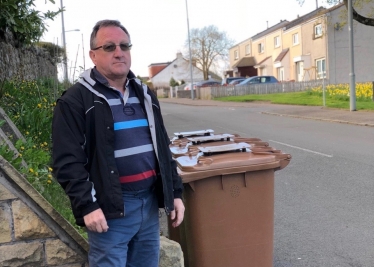 Charles Kennedy getting to grips with the bins